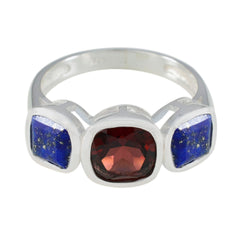 Isabel artisan multicolor trilogy ring with central red stone and two blue stones set in silver band