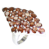 Natcha red gemstone statement ring with clustered round red stones set in a silver pave dome
