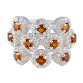 Liyana modern yellow gemstone ring featuring nine round orange stones with diamond halos