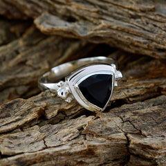Laura black solitaire ring with triangular black stone set in silver band on rustic wood