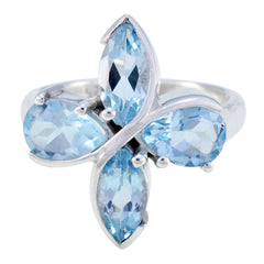Blue gemstone floral ring with four marquise-cut blue stones set in silver band