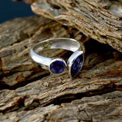 Jia blue gemstone toi et moi ring with two deep blue stones set in polished silver band on rustic wood