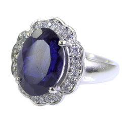 Laura blue halo ring for women with oval blue gemstone and surrounding clear stones in silver setting
