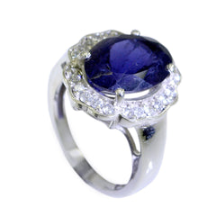 Laura blue halo ring for women featuring a large oval blue stone surrounded by small clear crystals