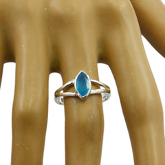 Nari blue solitaire geometric ring with marquise cut blue stone on silver band displayed on hand