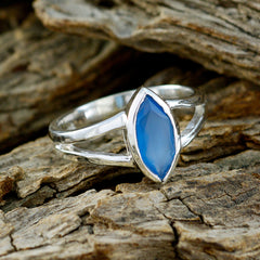 Nari blue solitaire geometric ring with silver band on textured wooden surface