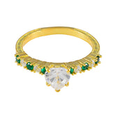 Angel gold ring featuring a heart-shaped center stone with green gemstone statement ring accents