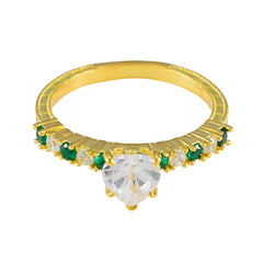 Angel gold ring featuring a heart-shaped center stone with green gemstone statement ring accents