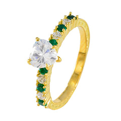 Angel gold ring featuring green gemstone statement ring design with heart-shaped clear center stone