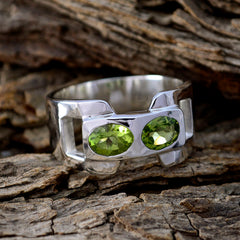 Siti silver green toi et moi ring with two oval green gemstones on rustic wood background