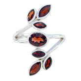 Leafy red gemstone ring by Teresa with multiple marquise and oval red stones on silver band