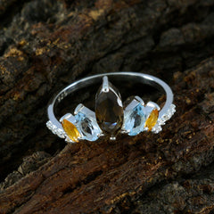 multicolor crown gemstone ring with marquise smoky center stone flanked by blue and yellow marquise gems and diamond accents