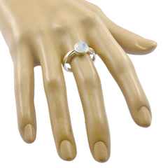 Maria white solitaire gemstone ring with round moonstone bezel set on sterling silver band displayed on mannequin hand