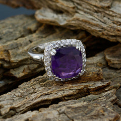 Priya purple halo gemstone ring with cushion-cut purple gemstone surrounded by small clear stones on silver band
