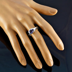 Sofia purple solitaire ring with a teardrop gemstone on a mannequin hand