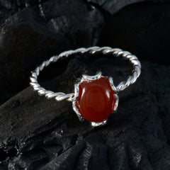 Ying red gemstone solitaire ring with twisted silver band and smooth oval red stone