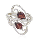 Cecilia red gemstone toi et moi ring with two pear-shaped red stones set in silver swirl design