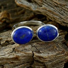 Lucy abstract blue gemstone ring with two oval blue stones set in silver on rustic wood