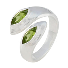 Lara abstract green toi et moi ring featuring two marquise green gemstones set in polished silver band