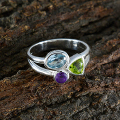 Mathilde silver ring with blue oval green triangle and purple round stones on wood background abstract multicolor gemstone ring