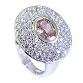 Ivana abstract multicolor halo ring featuring a pink oval center stone surrounded by pave white diamonds on polished silver band