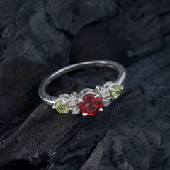 Meera abstract multicolor trilogy ring with a red center stone and green and clear side stones on silver band