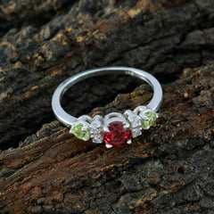 Meera abstract multicolor trilogy ring with red, green, and clear stones on a silver band