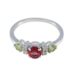 Meera abstract multicolor trilogy ring with red center stone, green side stones, and silver band