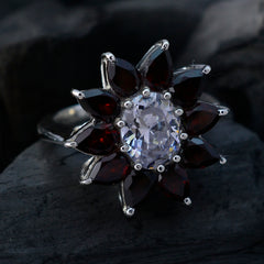 Ellie abstract red gemstone ring with central clear round stone and petal shaped deep red garnets in silver setting