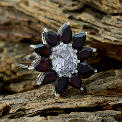 Ellie abstract red gemstone ring with central white gemstone and teardrop red stones in floral silver setting on rustic wood