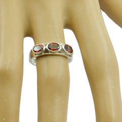 Saanvi abstract red trilogy ring featuring three red gemstones set in a silver band on a finger