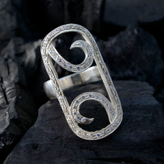 Ella abstract white statement ring with sparkling crystals in a unique swirl design on dark background