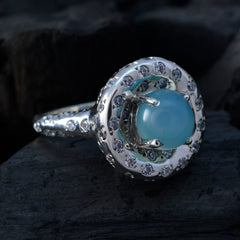 Lucia aqua gemstone statement ring with round aqua cabochon center haloed by clear crystals on silver band