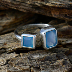 Lakshmi aqua gemstone toi et moi ring with two blue gemstones set in silver band on wood