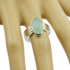 Nia aqua solitaire gemstone ring with oval aqua stone set in silver band on hand model