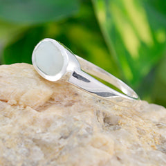 Seo-yeon silver aqua solitaire ring with a smooth round aqua gemstone on a natural stone background