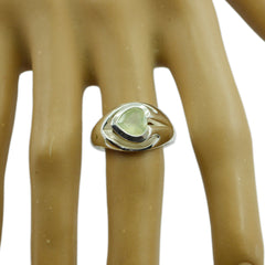 Natalia aqua solitaire ring with heart-shaped aqua gemstone set in silver band on display hand