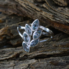 Rebeca artisan blue gemstone ring with six marquise-cut blue stones set in silver band on rustic wood