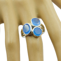 Dewi artisan blue gemstone ring with three faceted blue stones set in silver on finger