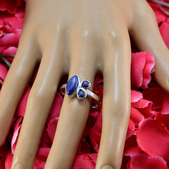 Carla artisan blue gemstone ring with three blue stones on silver band displayed on hand