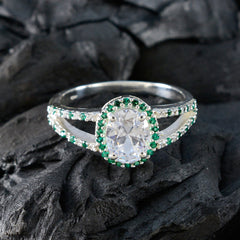 Joaquina artisan green halo ring with a large oval clear center stone and green accents on silver band