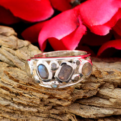 Sofia artisan grey gemstone ring with multiple grey stones set in silver band on rustic wood