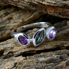 Araya artisan multicolor gemstone ring with purple and green stones set in silver band on textured wood