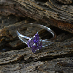 Layla artisan purple gemstone ring silver band with three marquise amethyst stones on rustic wood