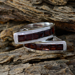 Isla artisan red gemstone ring with square red stones set in polished silver band on rustic wood