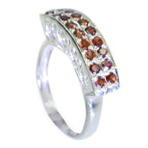 Claire artisan red gemstone ring featuring multiple small red gemstones set in silver band