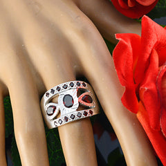 Bianca artisan red gemstone ring featuring intricate silver design with red stones on display hand