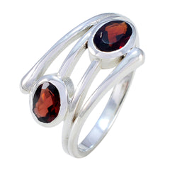 Artisan toi et moi ring with two oval red gemstones set in polished silver band by Maria