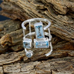 Ava Signet Blue quarter ring online with multiple blue gemstones set in silver on rustic wood