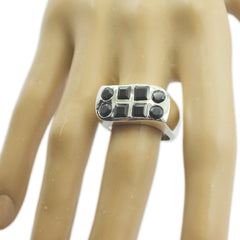 Nora black gemstone statement ring featuring multiple black stones on a silver band worn on finger